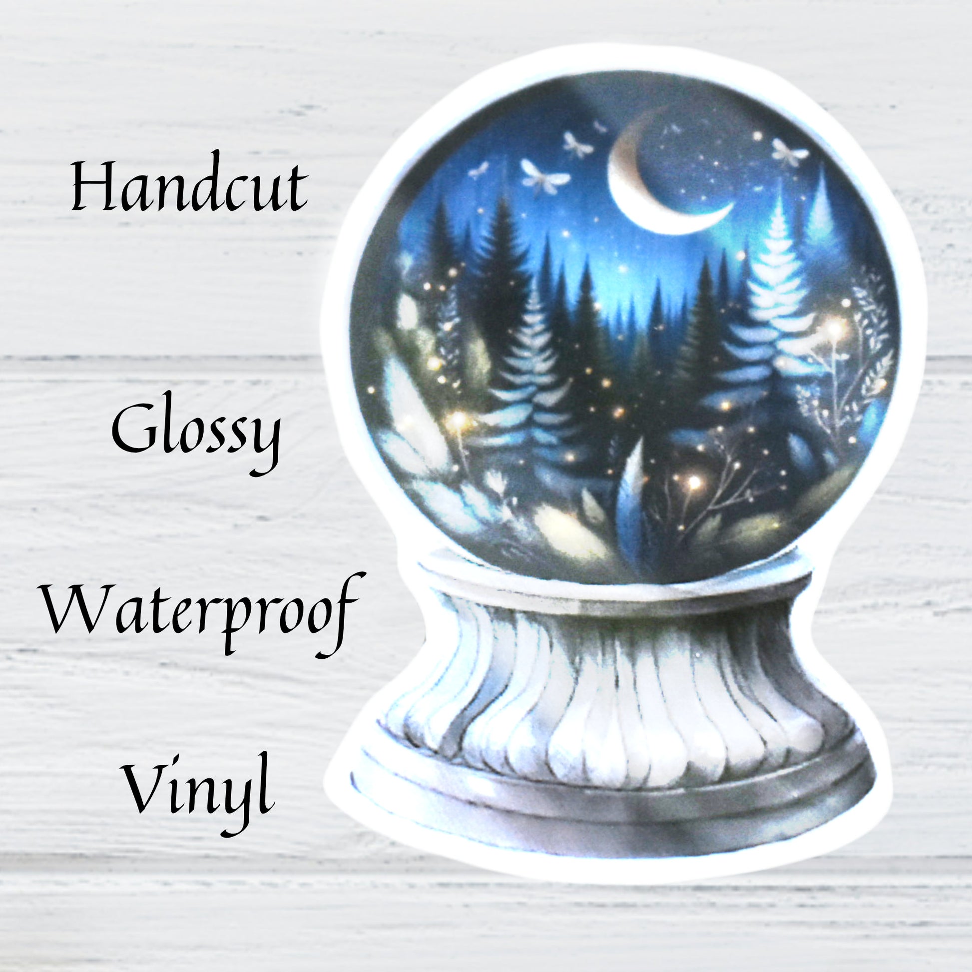 Hand cut waterproof vinyl fantasy crystal ball sticker featuring night-time evergreen forest with crescent moon and fairy lights.