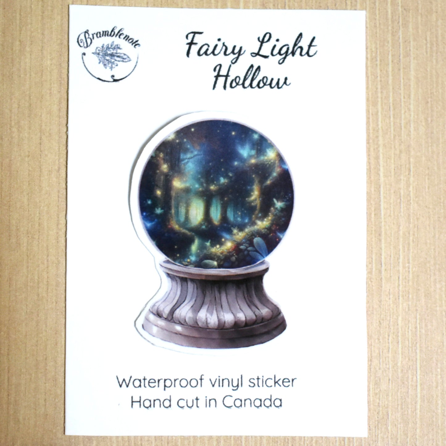 Fairy Light Hollow crystal ball sticker featuring a forest floor illuminated with fairy lights under tree trunks, hand-cut vinyl