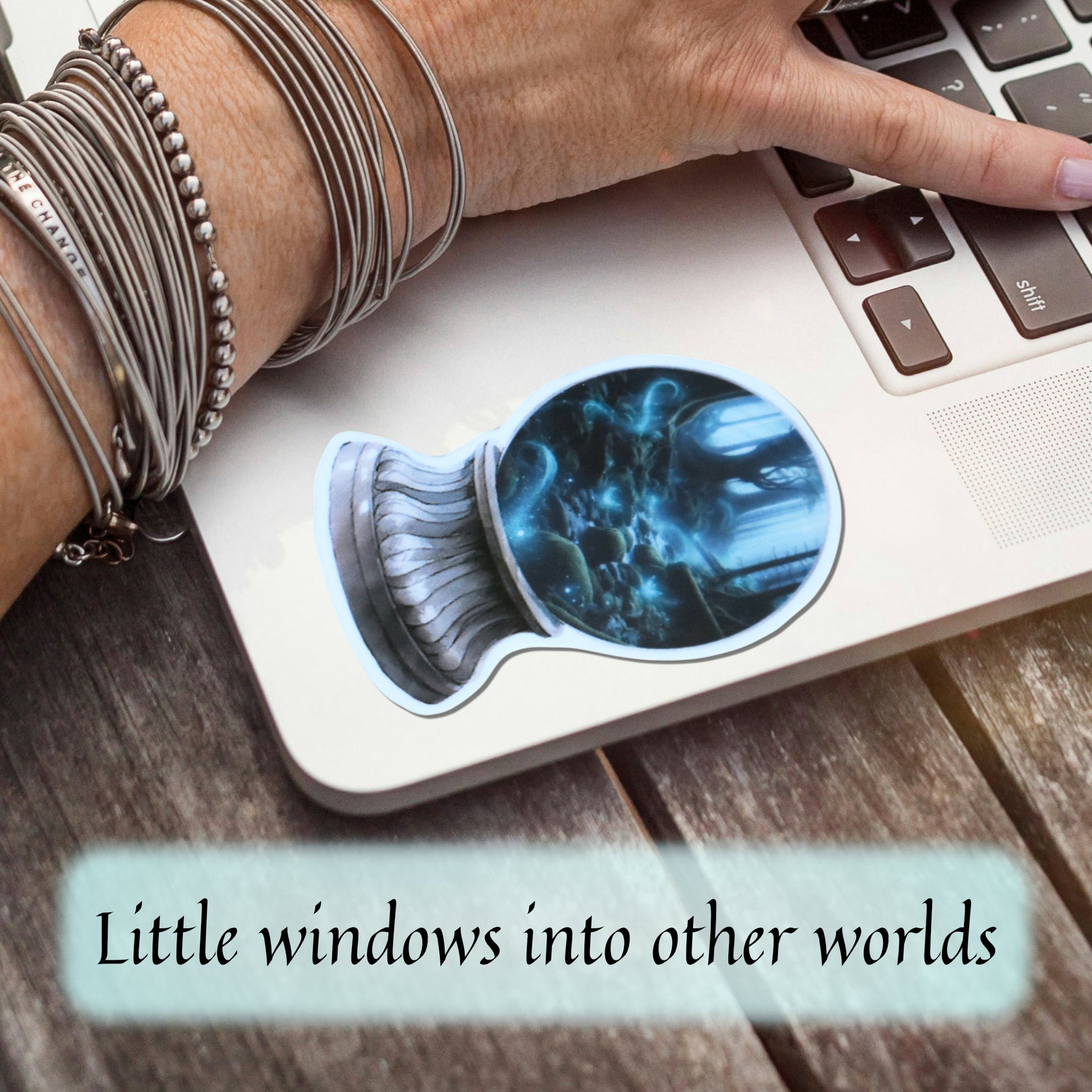 Laptop  on a wooden desk with a glossy waterproof vinyl fantasy sticker featuring glowing forest river.